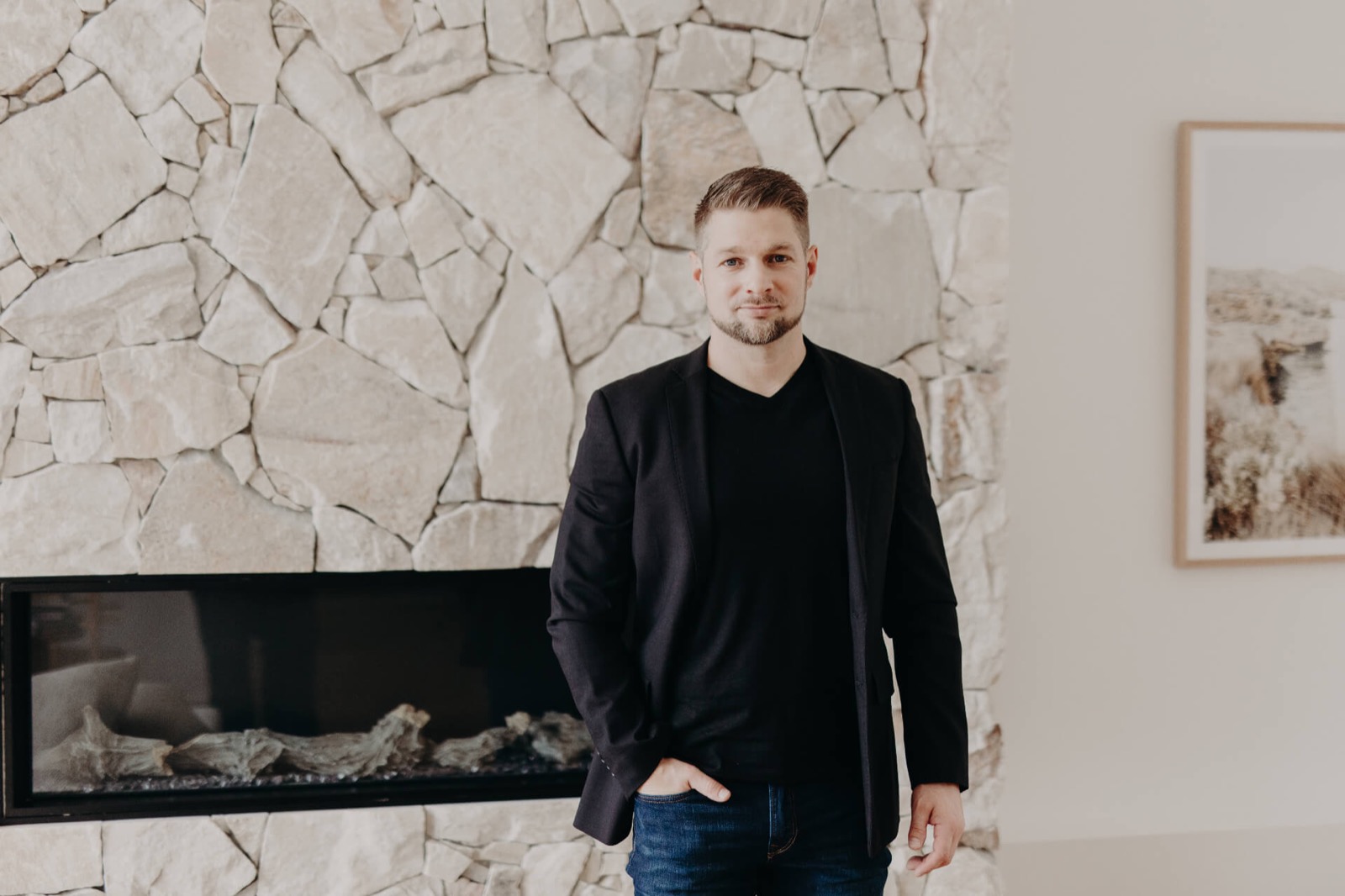 Todd Polke standing in front of a stone fireplace